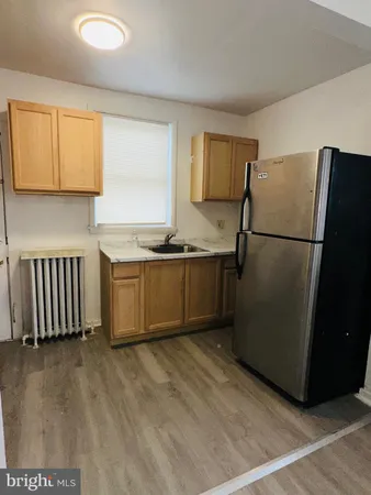 a kitchen with a refrigerator a sink and a stove