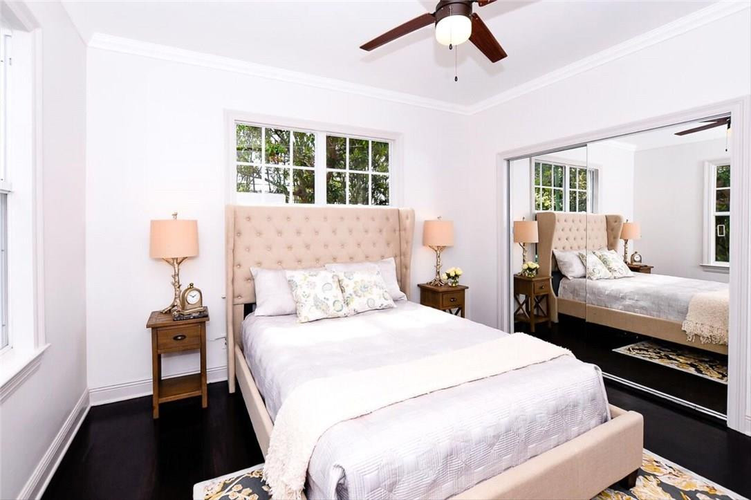 734 Avon Road West Palm Beach, FL 33401 - Photo 11 of 26 a bedroom with a bed and wooden floor