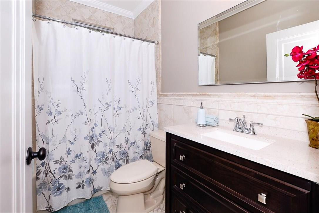 734 Avon Road West Palm Beach, FL 33401 - Photo 14 of 26 a bathroom with a granite countertop sink toilet and shower