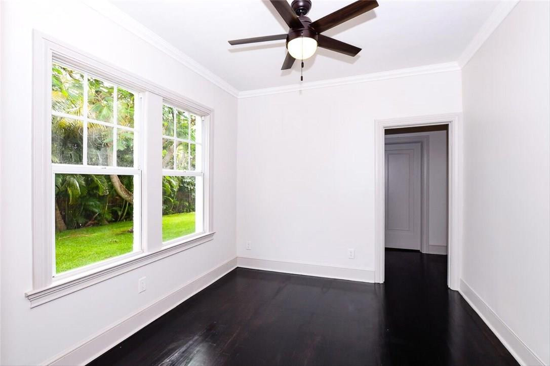734 Avon Road West Palm Beach, FL 33401 - Photo 18 of 26 an empty room with wooden floor fan and windows
