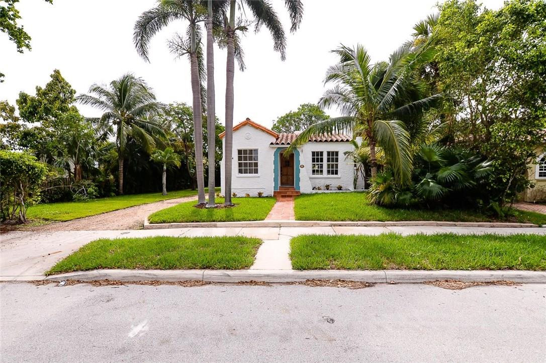 734 Avon Road West Palm Beach, FL 33401 - Photo 2 of 26 a view of a house with a yard and palm trees