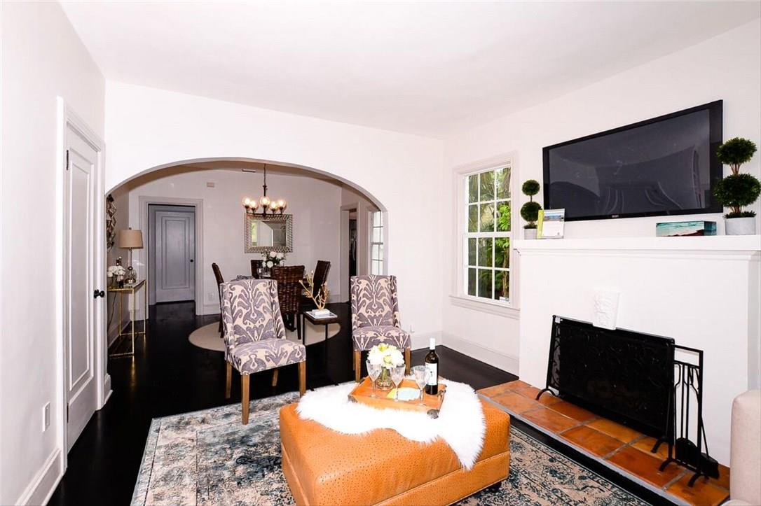 734 Avon Road West Palm Beach, FL 33401 - Photo 3 of 26 a living room with furniture a flat screen tv and a fireplace