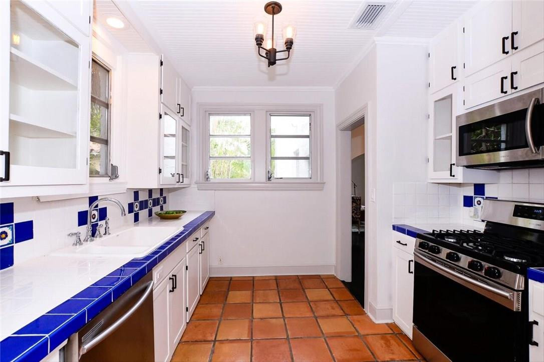 734 Avon Road West Palm Beach, FL 33401 - Photo 6 of 26 a kitchen with sink cabinets and appliances