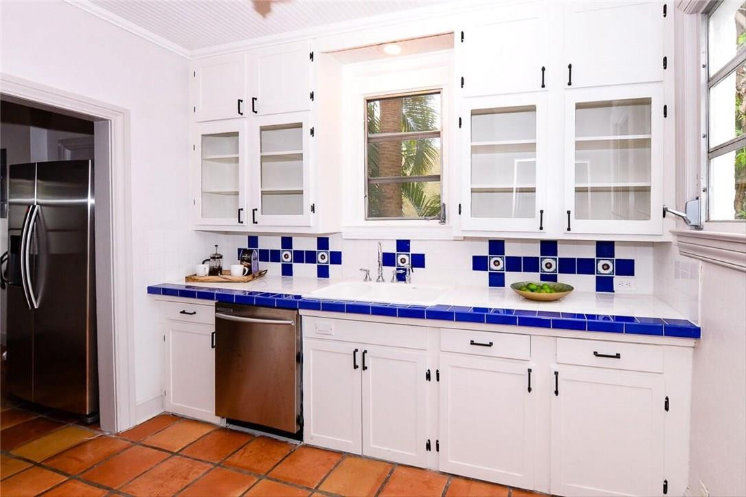 734 Avon Road West Palm Beach, FL 33401 - Photo 7 of 26 a kitchen with stainless steel appliances granite countertop a sink and cabinets