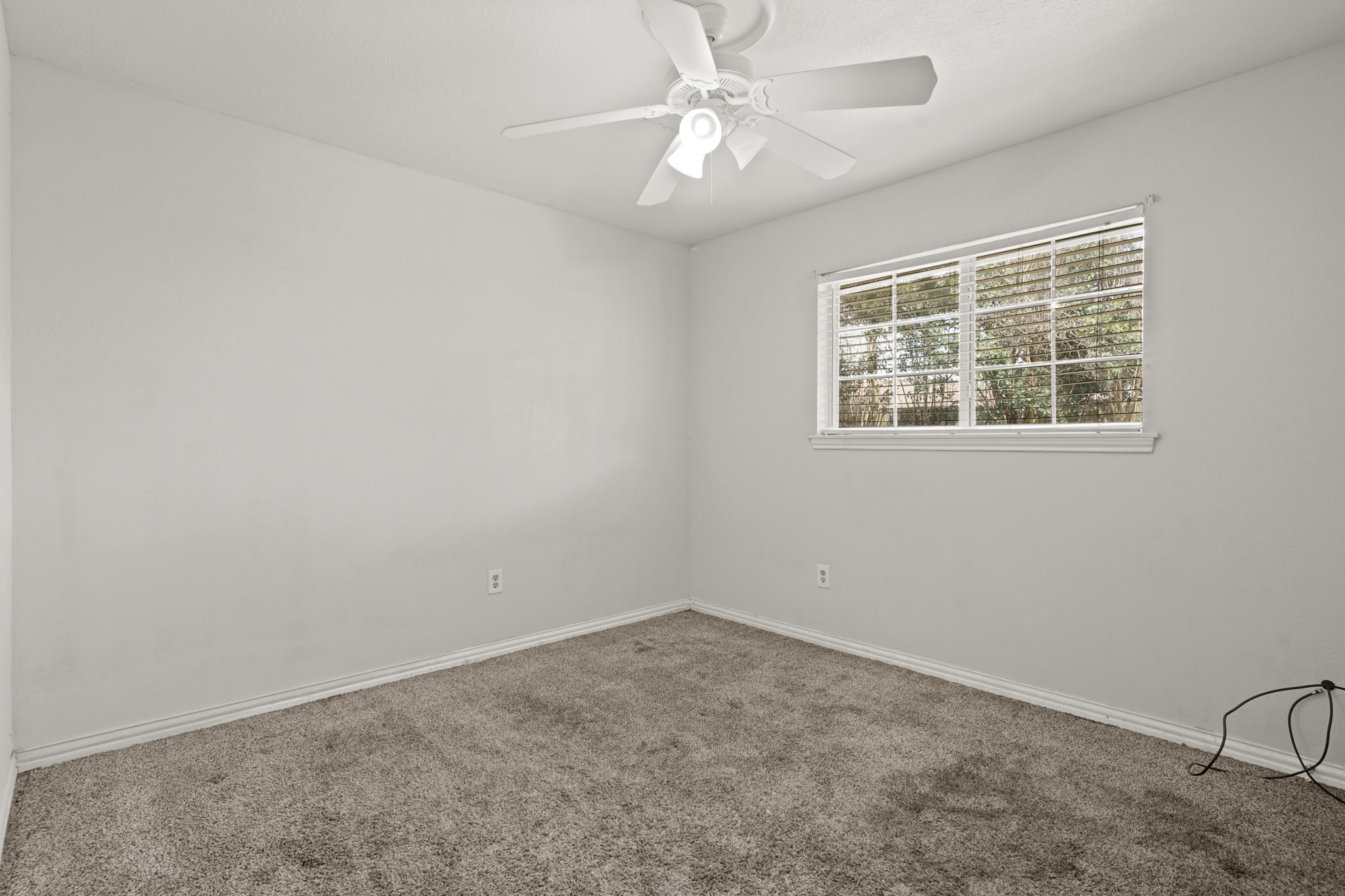 135 Mill Stream Lane Houston, TX 77060 - Photo 8 of 11 Second bedroom has soft carpet flooring and a ceiling fan.