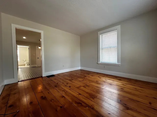 a view of a street with a car parked in the road