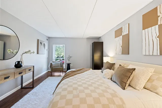 a bedroom with a large bed and a dresser