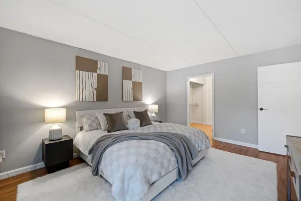 a bedroom with a bed and lamp with window