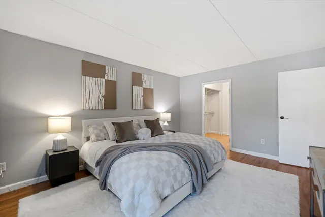 a bedroom with a bed and lamp with window