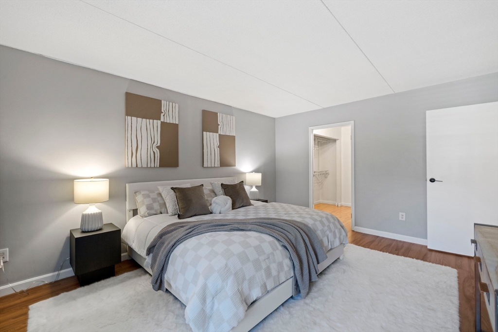 50-56 Broadlawn Park, Unit 221 Boston, MA 02467 - Photo 16 of 29 a bedroom with a bed and lamp with window