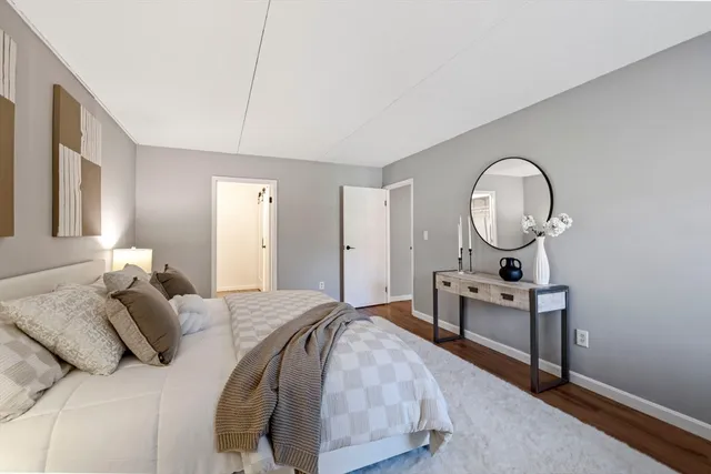 a bedroom with bed and a chandelier