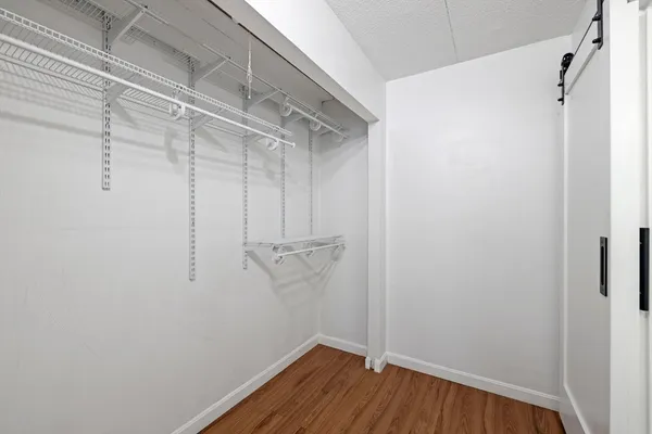 a view of a room with wooden floor