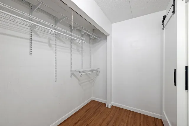 a view of a room with wooden floor