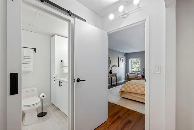 a en suite bathroom with a granite countertop sink and a mirror