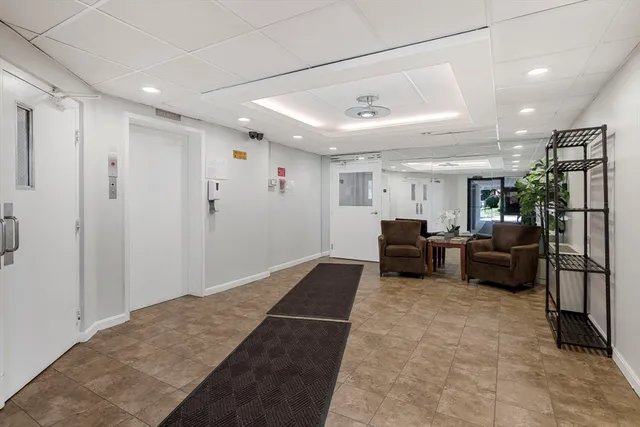 a living room with furniture a couch and a ceiling fan