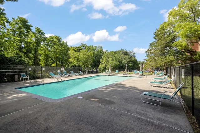 a view of a swimming pool with a yard