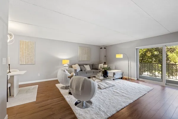 a living room with furniture window and wooden floor
