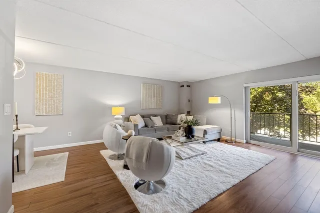 a living room with furniture window and wooden floor