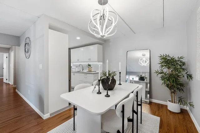 a view of a dining room with furniture wooden floor and chandelier