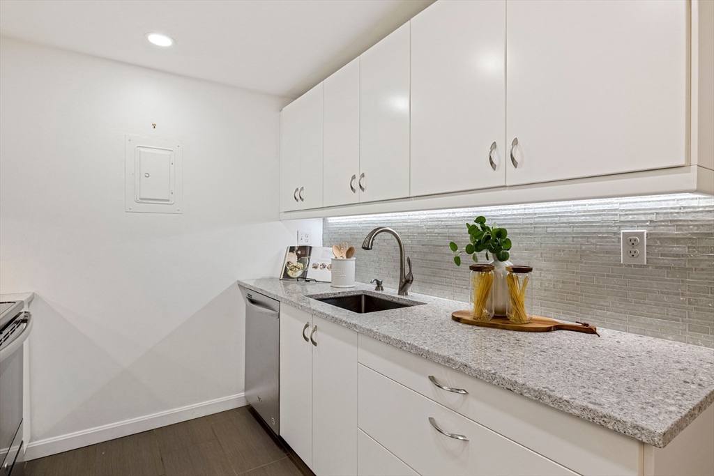 50-56 Broadlawn Park, Unit 221 Boston, MA 02467 - Photo 8 of 29 a kitchen with sink and white cabinets