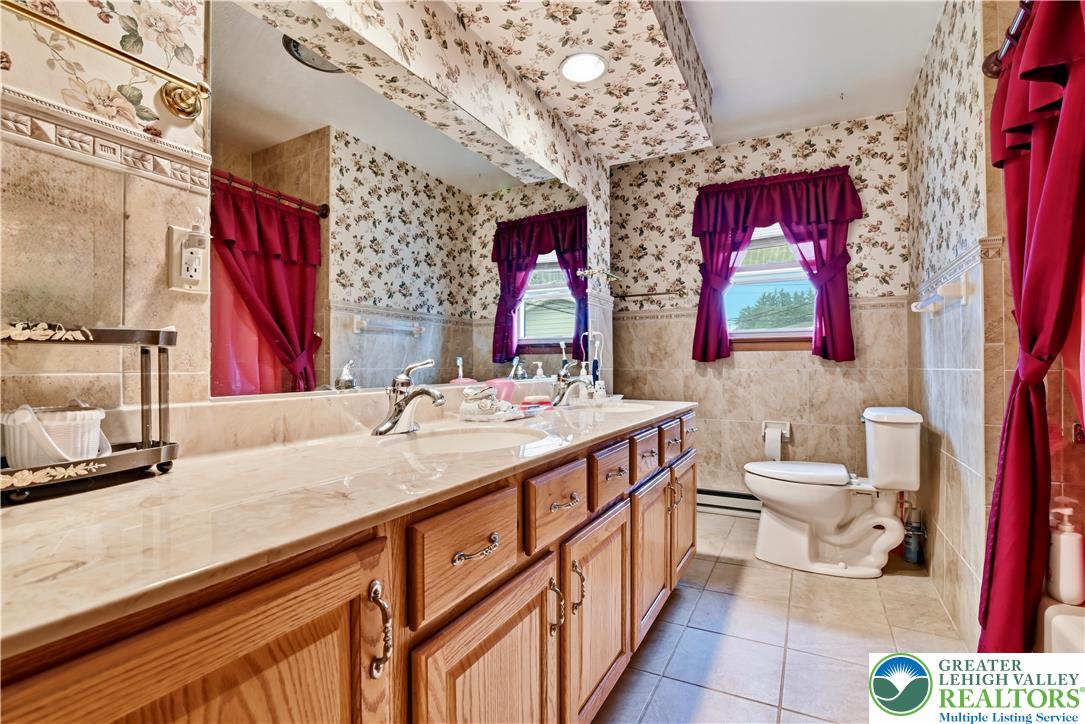 3303 Barklay Road Whitehall, PA 18052 - Photo 27 of 39 Dual vanities with gleaming faucets highlight this well-appointed bathroom.