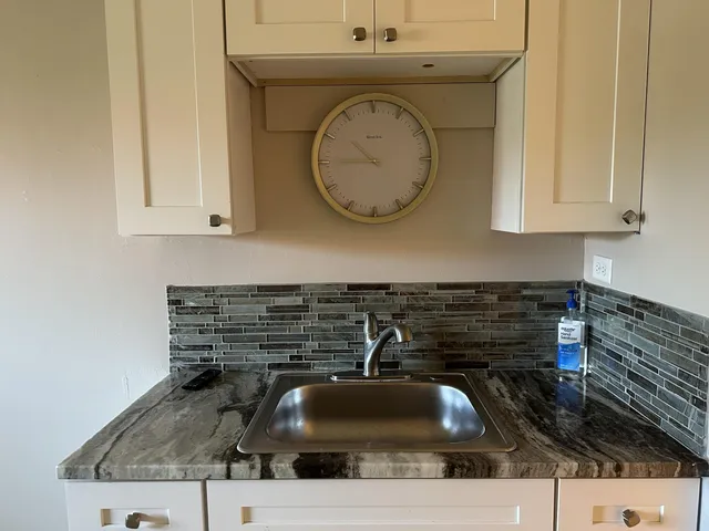 a bathroom with a granite countertop and sink