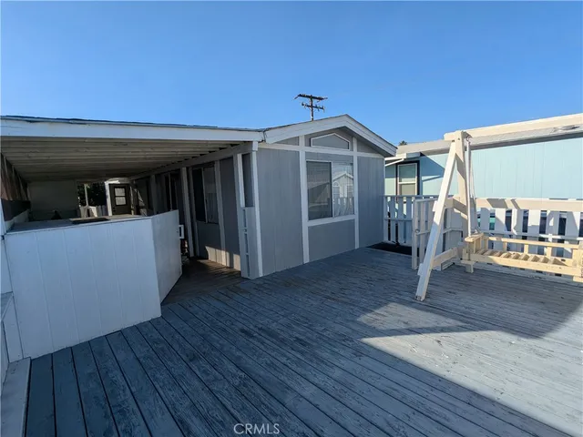 a view of a house with wooden floor and a yard