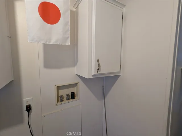 a view of a storage & utility room with a window