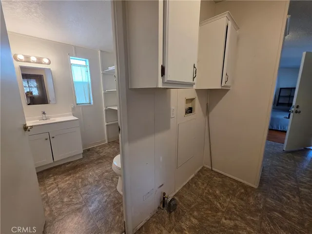 a view of a storage and utility room with a sink