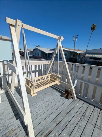 a view of outdoor space with wooden floor and seating