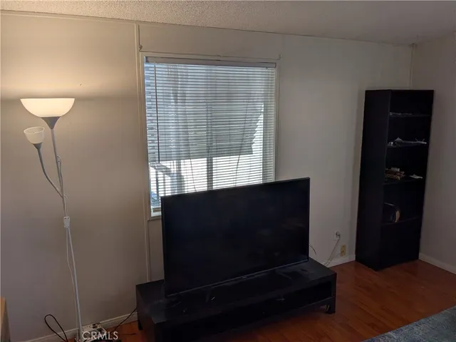 a living room with a flat screen tv and a window