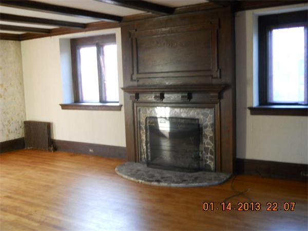 321 Longhill Street Springfield, MA 01108 - Photo 4 of 5 a living room with fireplace and a wooden floor