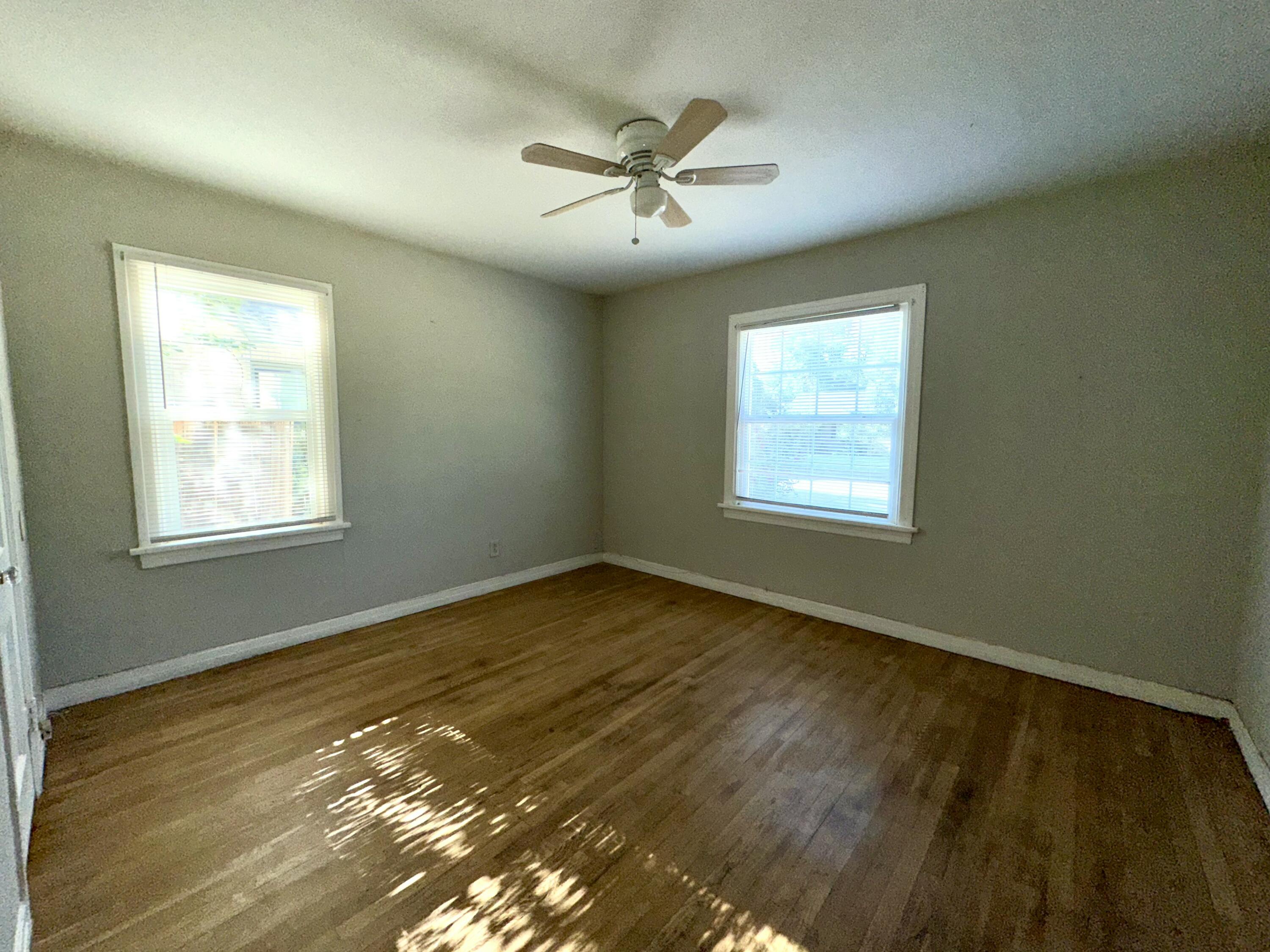 3012 22nd Street Lubbock, TX 79410 - Photo 10 of 11 a view of an empty room with wooden floor and a window