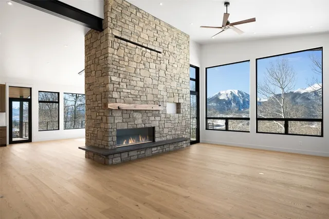 a living room with a fireplace with wooden floor