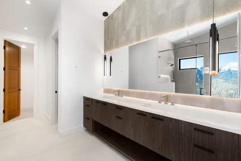 a bathroom with a double vanity sink mirror and double