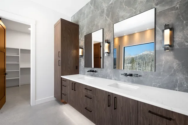 a bathroom with a double vanity sink and a mirror