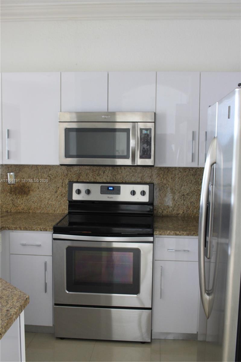 11675 Northwest 78th Lane Doral, FL 33178 - Photo 3 of 12 a stove top oven sitting inside of a kitchen