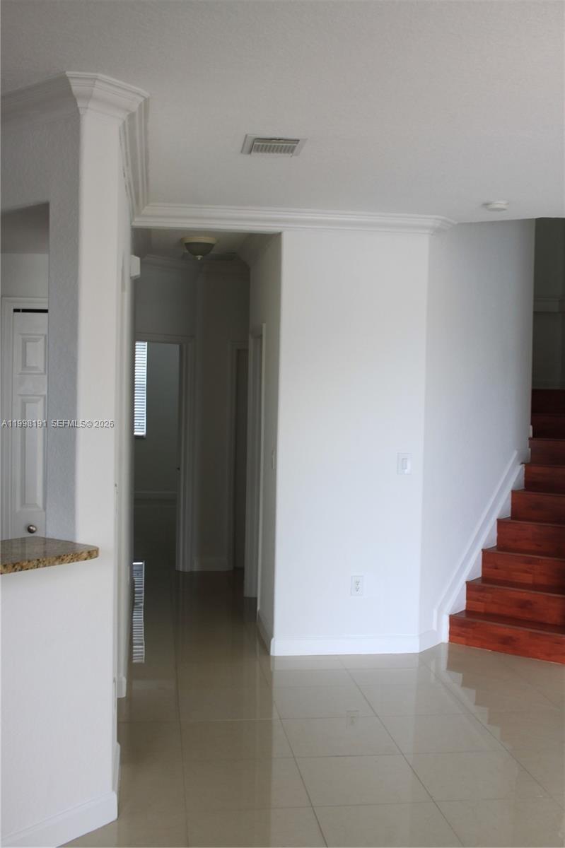 11675 Northwest 78th Lane Doral, FL 33178 - Photo 6 of 12 a view of an empty room with wooden floor and a bathroom