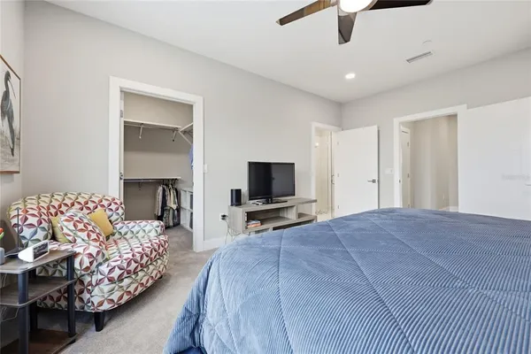 a kitchen with stainless steel appliances a refrigerator a stove a sink dishwasher and a dining table with wooden floor