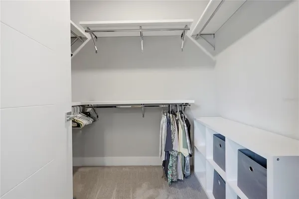 a view of a kitchen with cabinets stainless steel appliances and a window