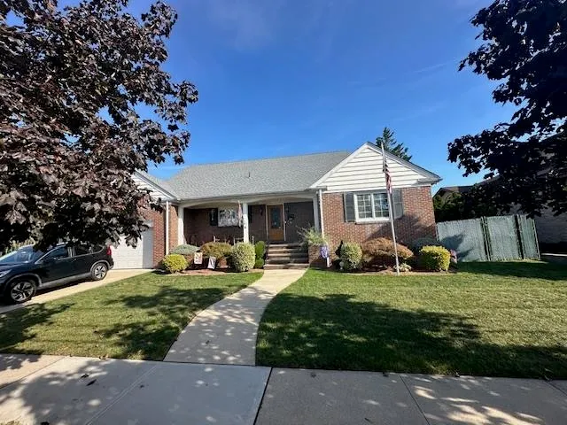 a front view of a house with a garden