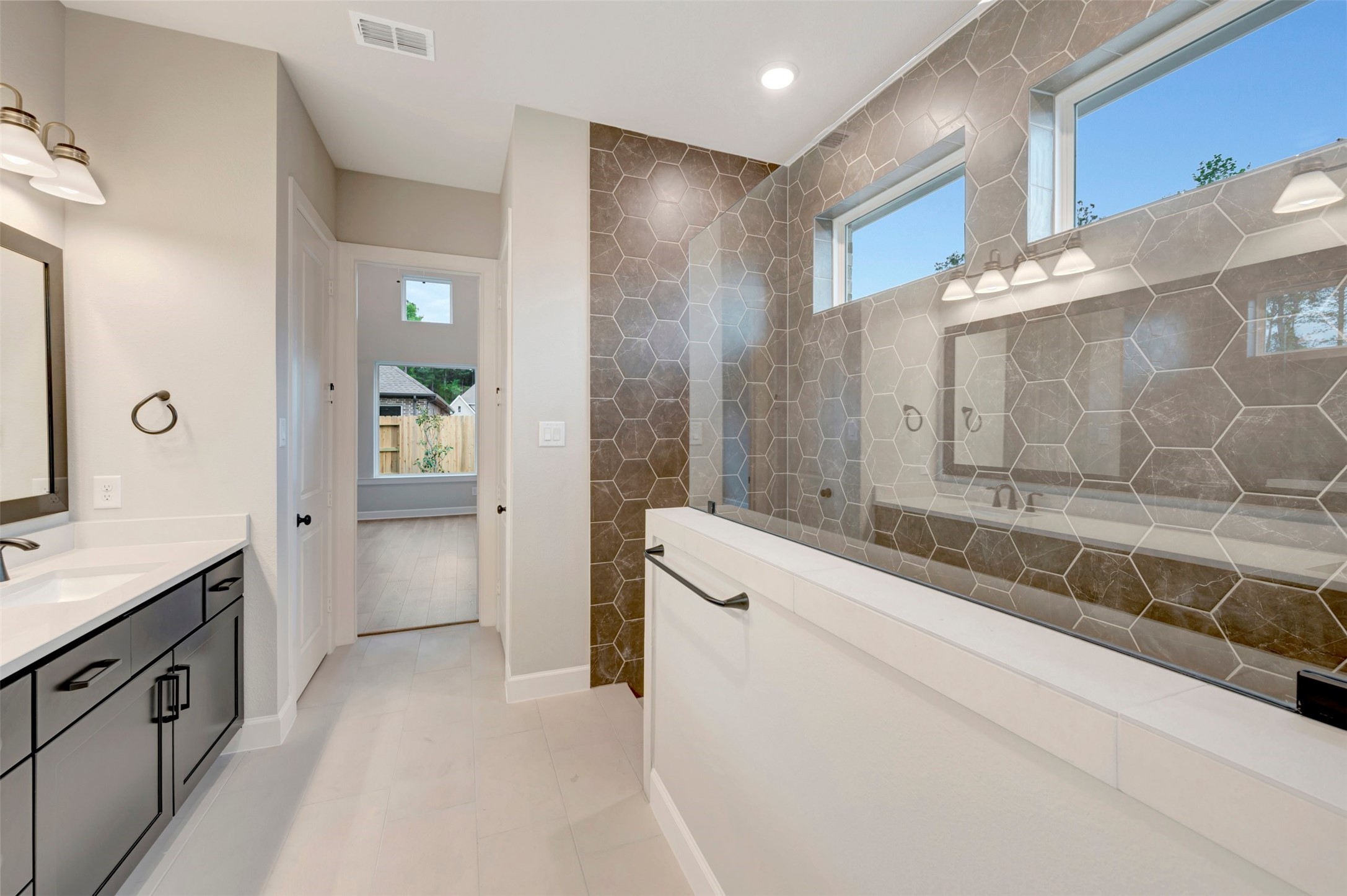 15722 Terracotta Terrace Conroe, TX 77302 - Photo 46 of 50 a spacious bathroom with a granite countertop sink mirror and a bath tub