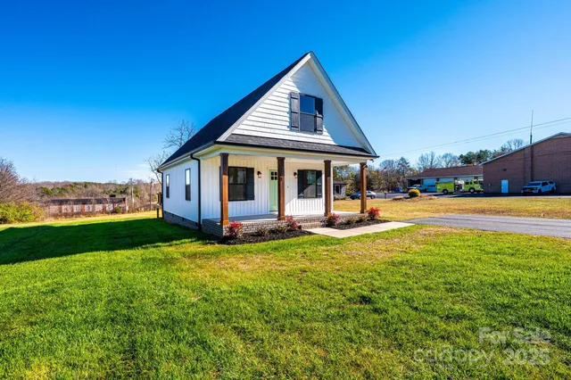a view of a house with swimming pool and a yard
