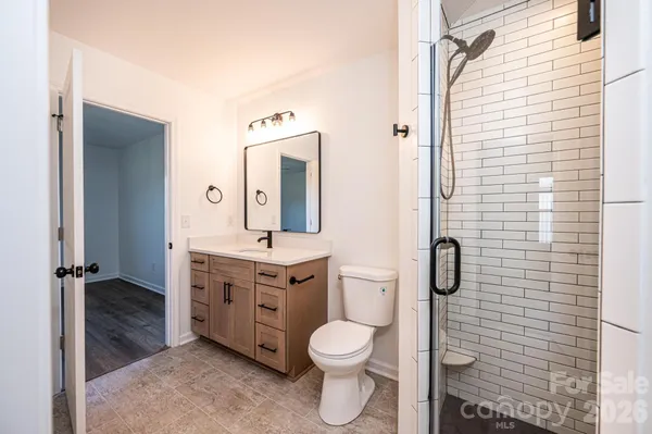 a bathroom with a toilet a sink and mirror