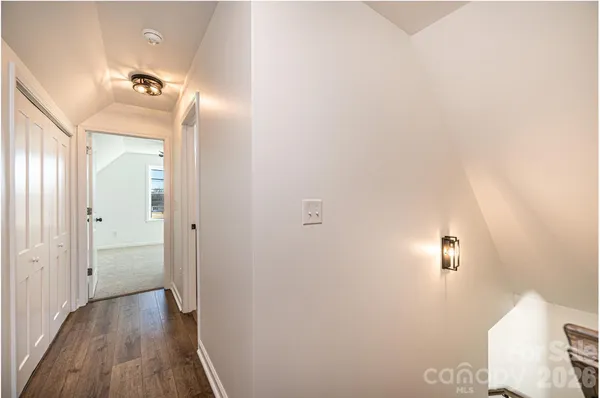 a view of a hallway with wooden floor