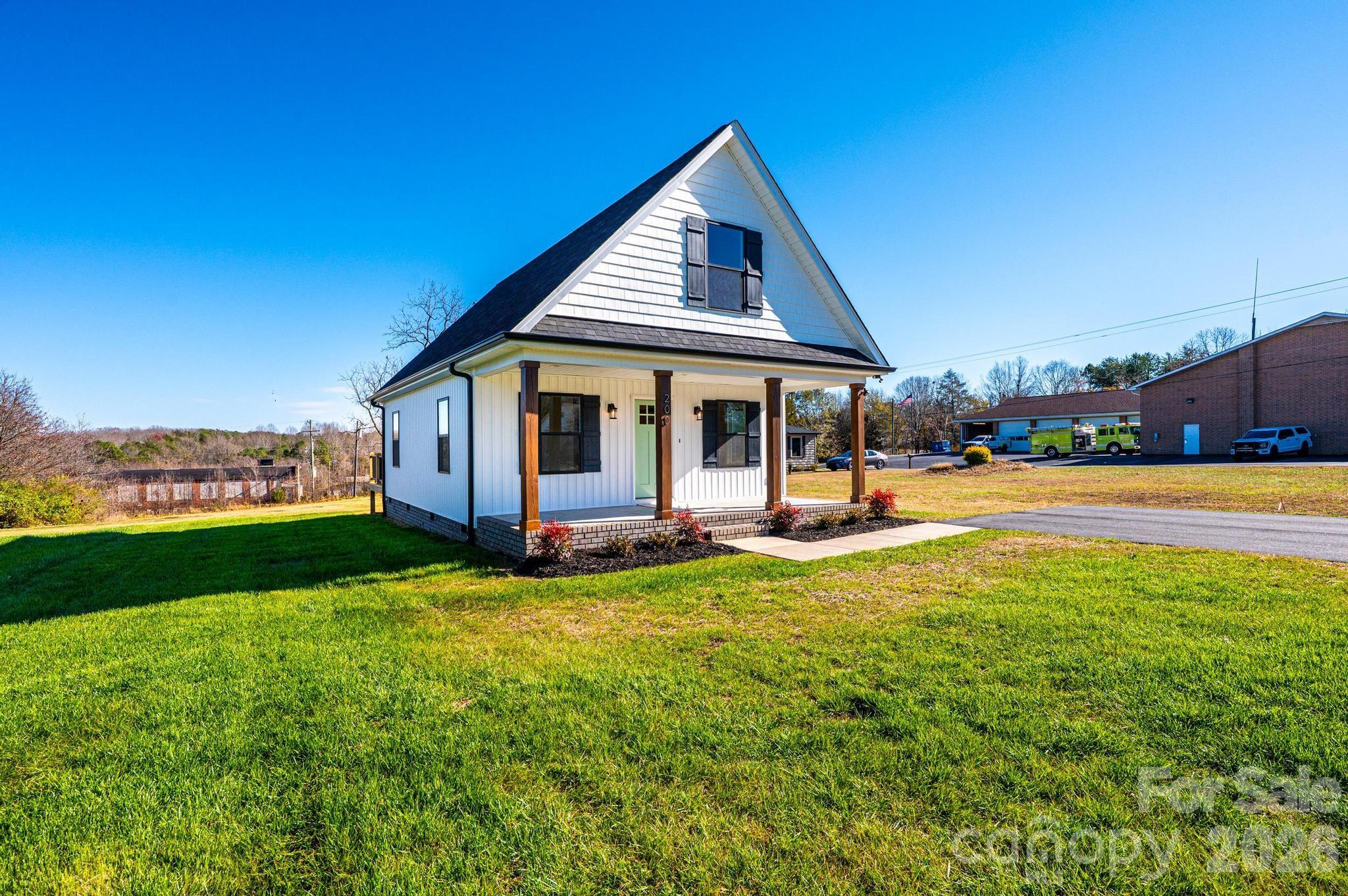 200 North Center Street Hildebran, NC 28637 - Photo 2 of 25 a view of a house with swimming pool and a yard