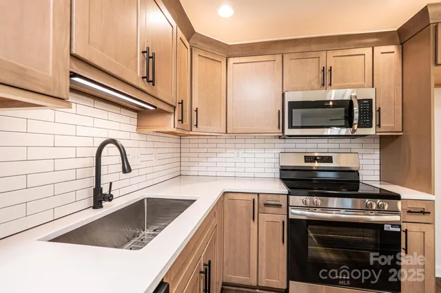 a kitchen with a sink a stove and cabinets
