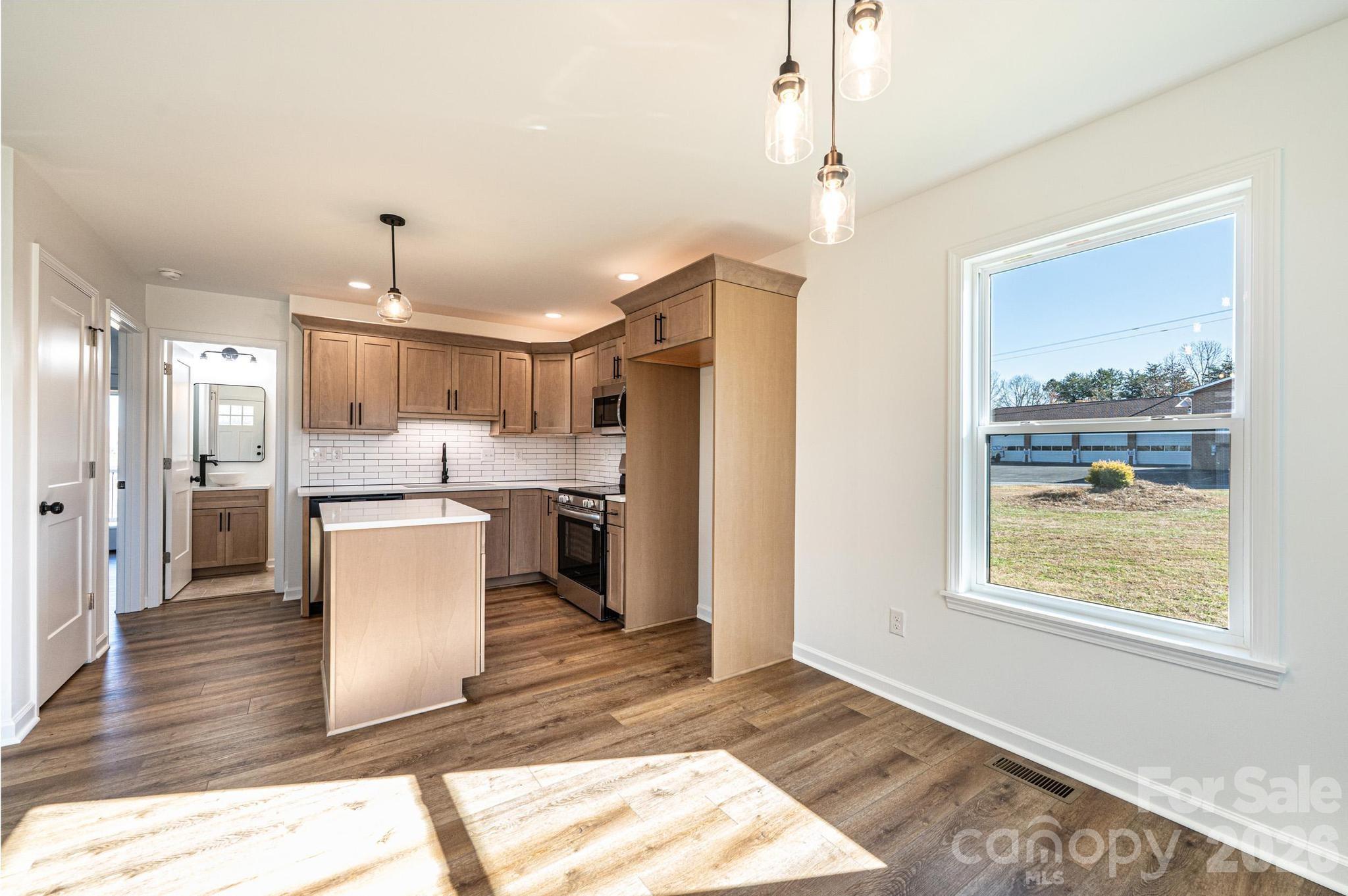 200 North Center Street Hildebran, NC 28637 - Photo 5 of 25 a open kitchen with white cabinets and white appliances