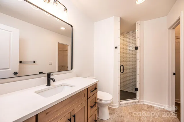 a bathroom with a sink toilet a shower and a mirror