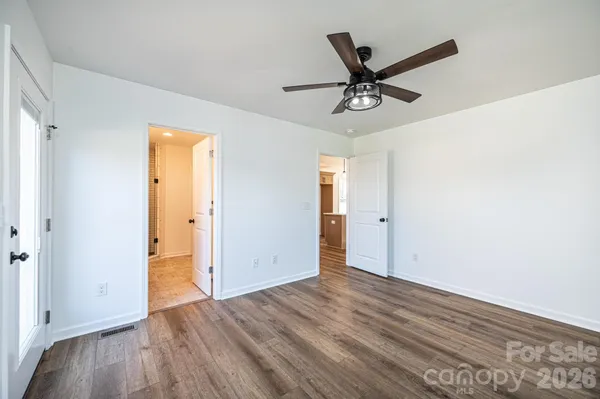 a view of a livingroom with a hardwood floor and a ceiling fan